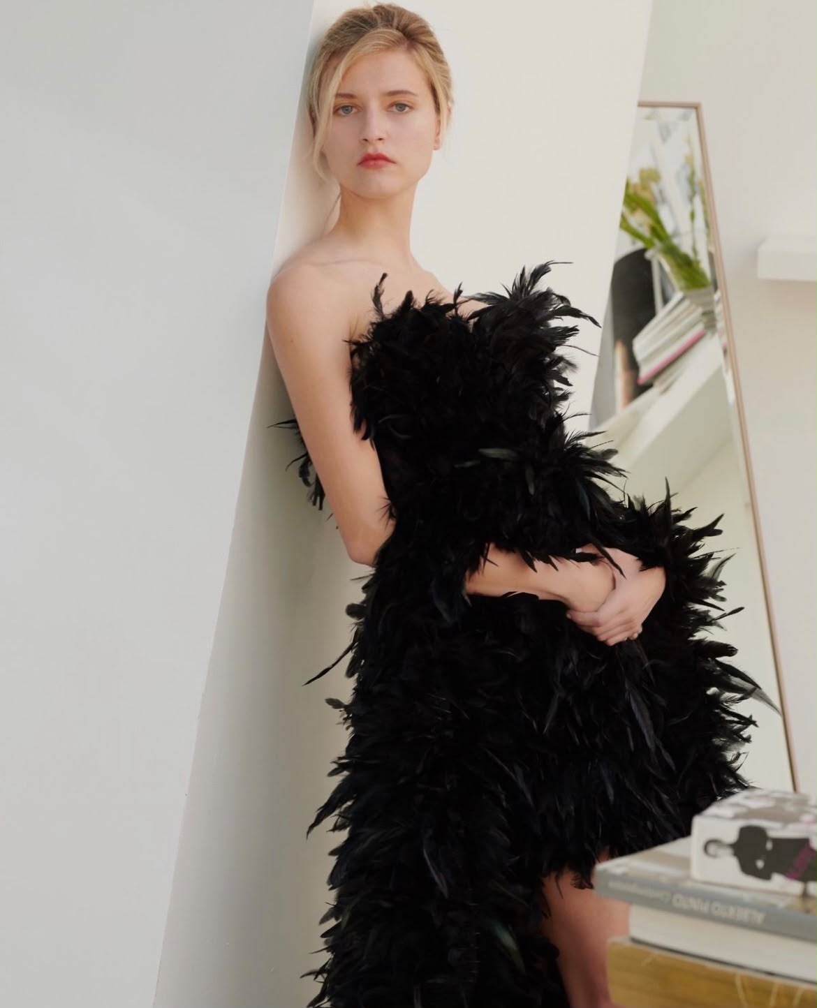 Ana Schurmann for Vogue Arabia, shot by Mateusz Stefanowski — black feather gown against a white wall